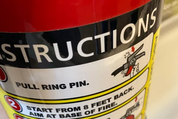A fire extinguisher with its instructions sticker