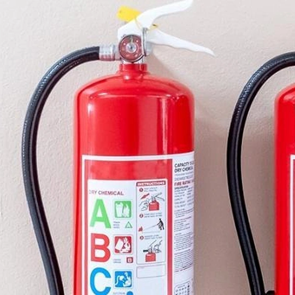 Two fire extinguishers labelled with an ABC fire class sticker